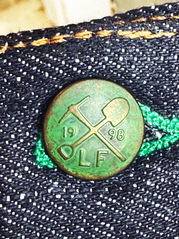Green metal work button with '1998' and pick and shovel on botton