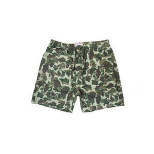 A pair of camouflage print shorts with a green, brown, and beige camo pattern, laid flat against a white background.