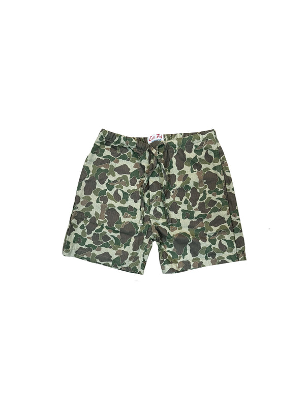 A pair of camouflage print shorts with a green, brown, and beige camo pattern, laid flat against a white background.