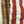 Close-up of a woven textile with vertical stripes in brown, rust red, and off-white.