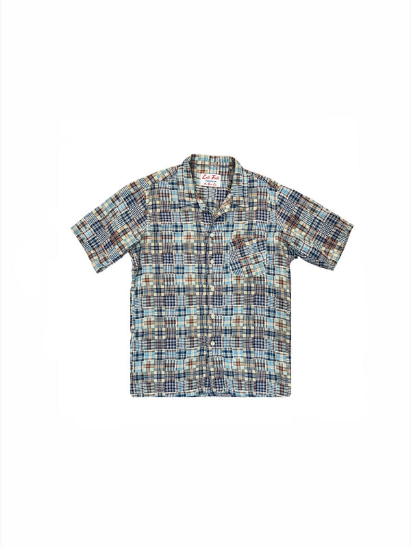 A short-sleeve button-up shirt with a multicolor plaid pattern in shades of blue, brown, beige, and white, laid flat against a white background.