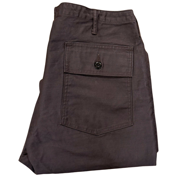 A pair of faded slate gray/black chinos with front and back patch pockets, high-rise waist, and long button front fly.
