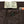 A pair of faded slate gray/black chinos with front and back patch pockets, high-rise waist, and long button front fly.
