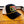 Black and white cap with 'Truck Stop Chic' logo on a wooden surface