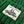 Close-up of a 'LEFT FIELD' label on a green textured fabric background