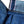 A pair of folded blue denim jeans with a label visible on the waistband.