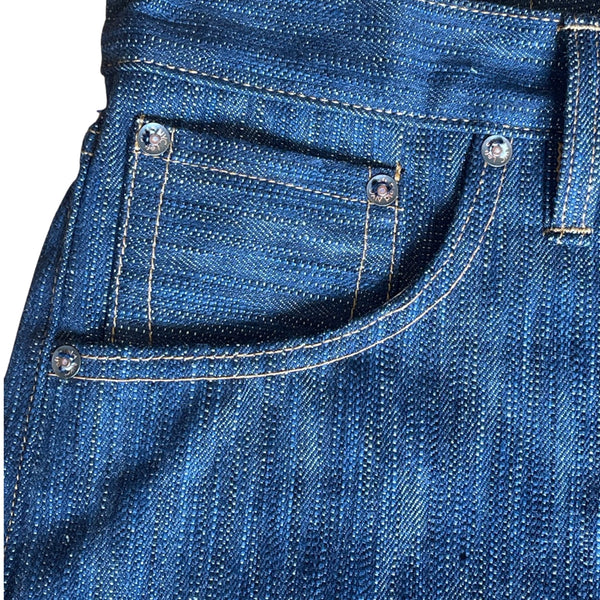 A pair of folded blue denim jeans with a label visible on the waistband.