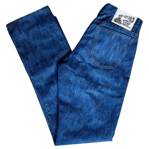 A pair of folded blue denim jeans with a label visible on the waistband.