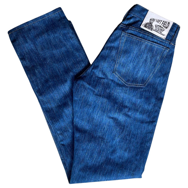 A pair of folded blue denim jeans with a label visible on the waistband.