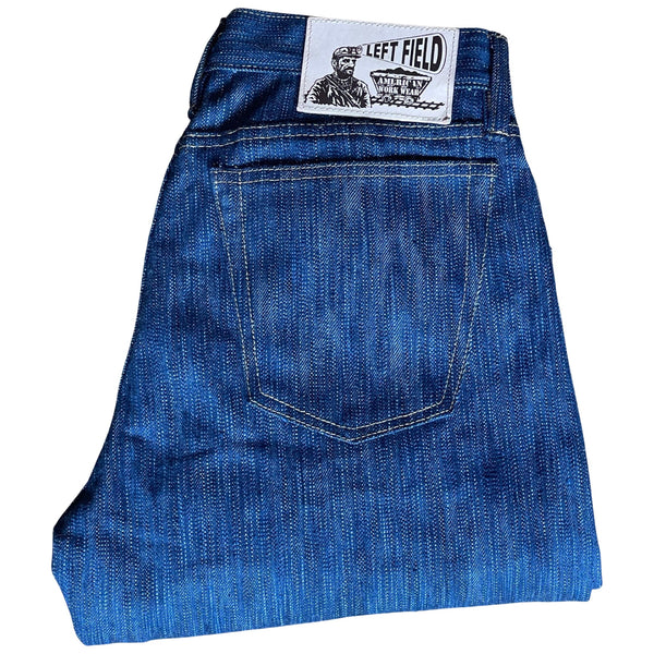 A pair of folded blue denim jeans with a label visible on the waistband.