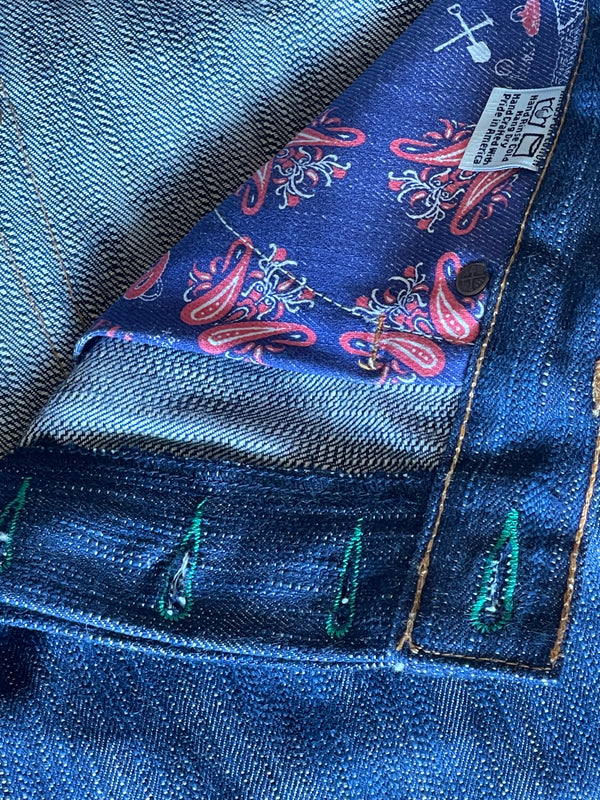 A pair of folded blue denim jeans with a label visible on the waistband.