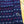 Close-up of a navy blue fabric with red and white patterns on a wooden surface