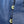 Close-up of a blue textured fabric with two buttons on a white background