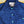 Blue jacket with a brand label on a wooden surface