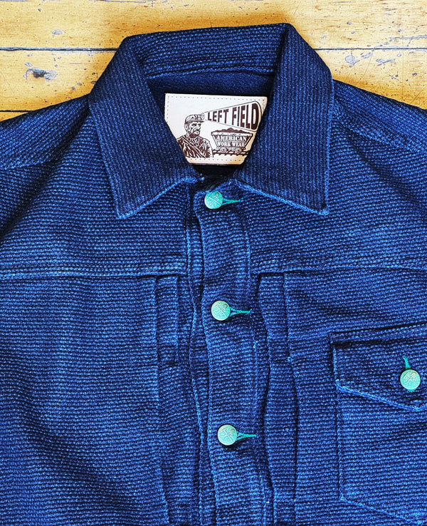 Blue jacket with a brand label on a wooden surface