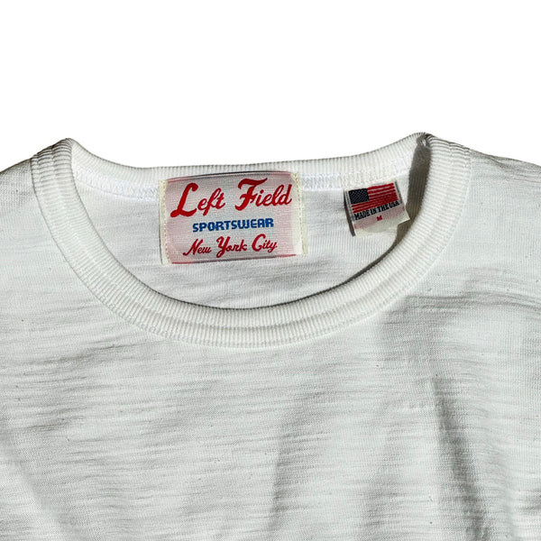 A white crew neck T-shirt with short sleeves, displayed against a plain background.