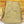 A pair of folded khaki pants with a buttoned front flap pocket, displayed on a rustic wooden plank background.