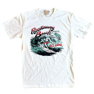 White crew neck t-shirt with a graphic print of a surfer and the text 'Rockaway Beach Surf Club' on the front.