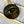 Bronze button with 'LEFT FIELD' text on a denim fabric background