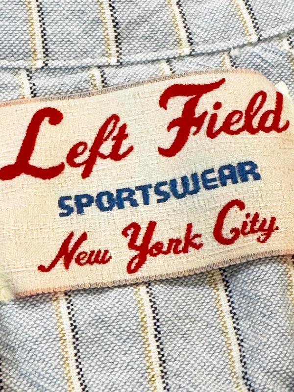 Label with 'Left Field Sportswear New York City' text on a striped fabric background