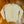 Cream-colored cable knit sweater on a wooden floor