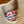 Close-up of a beige knitted sweater with a 'Left Field Sportswear New York City' label.