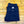 Folded navy blue pants with a brand label on a wooden floor.