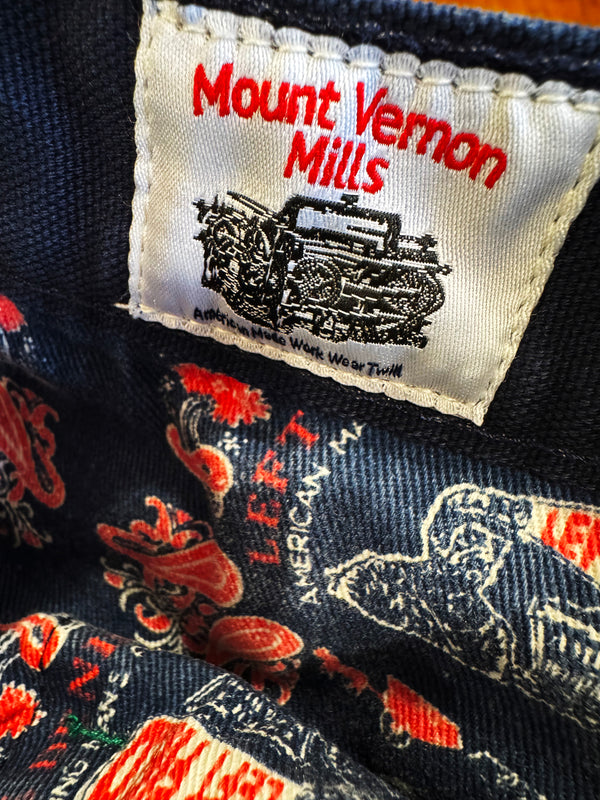 Close-up of a 'Mount Vernon Mills' label on denim fabric with rooster pattern.