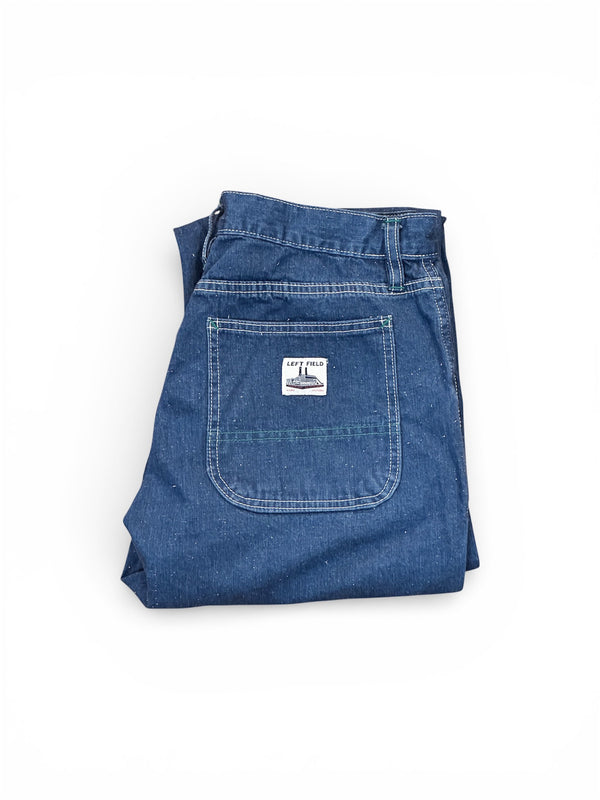Folded blue denim jeans with a brand label on a white background