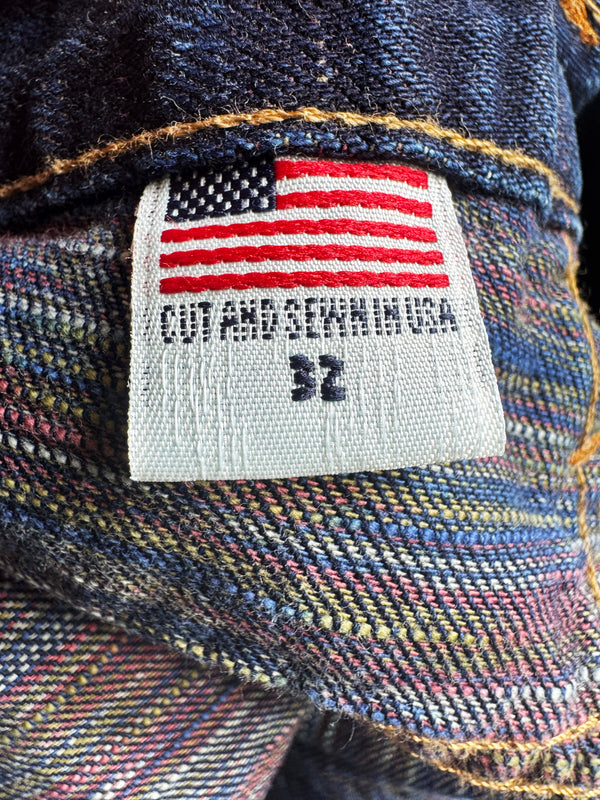 Denim jacket with an American flag label indicating 'Cut and Sewn in USA'.
