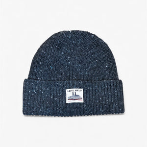 Dark blue knit beanie with a logo on a light gray background