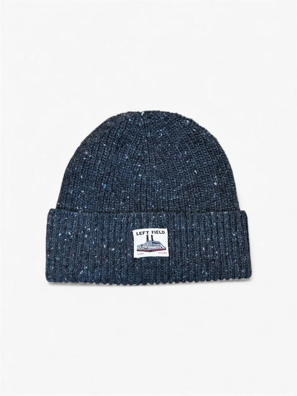 Dark blue knit beanie with a logo on a light gray background