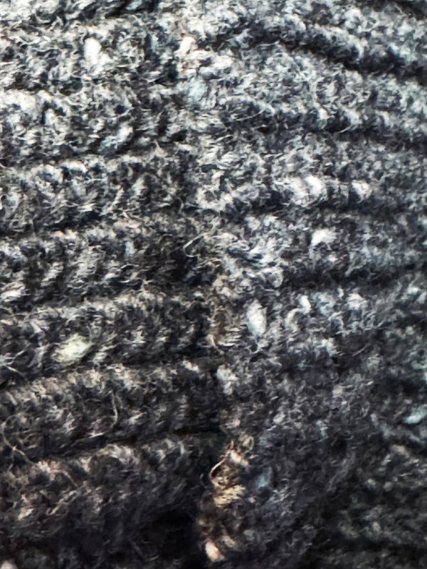 Close-up of textured dark fabric with a focus on pattern and texture.