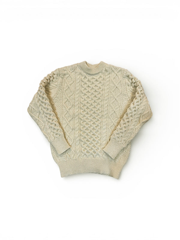 Beige cable knit sweater on a white background