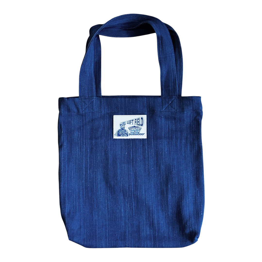 Blue tote bag with a label on a white background
