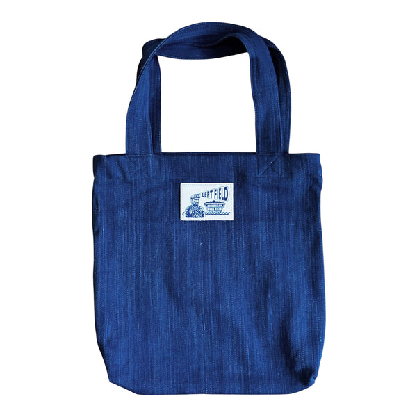 Blue tote bag with a label on a white background