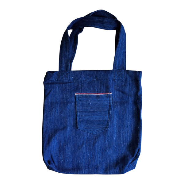 Blue tote bag with a pocket on a white background