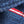 Close-up of a blue textured fabric with a red and white stripe.