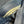 Close-up of blue denim fabric with a yellow stitching detail