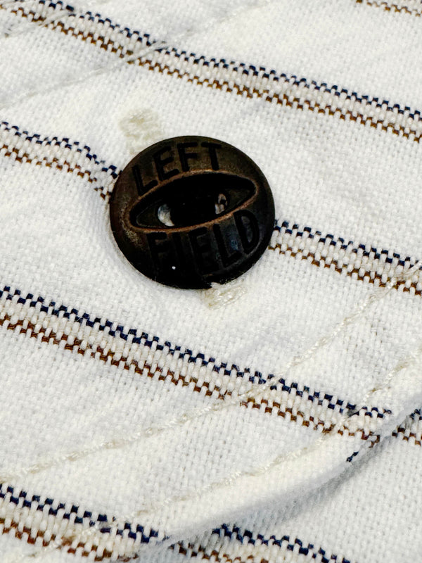 Black button with 'LEFT' text on a striped fabric background