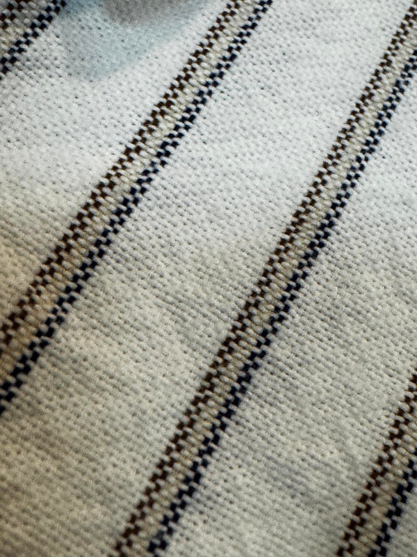 Close-up of a fabric with a striped pattern on a neutral background