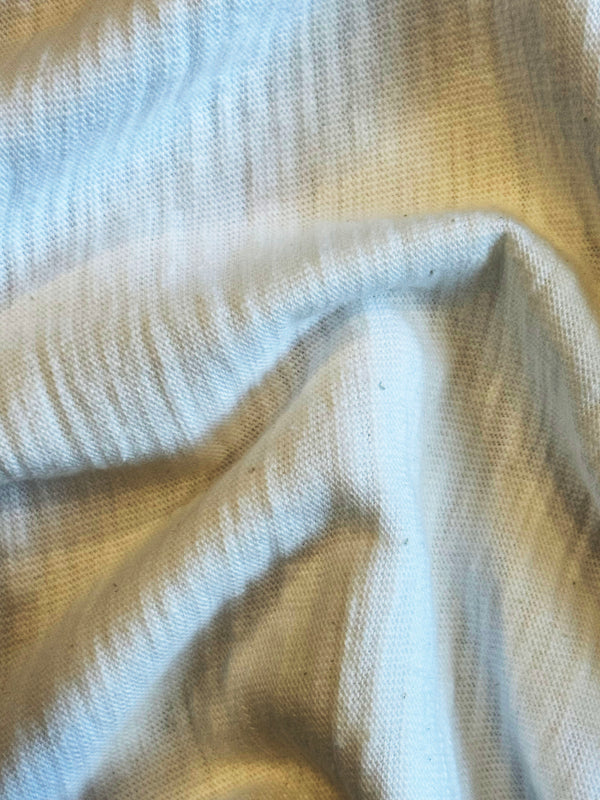 A white crew neck T-shirt with short sleeves, displayed against a plain background.