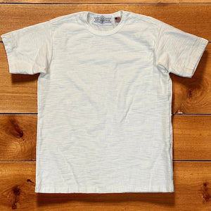 White t-shirt on a wooden surface