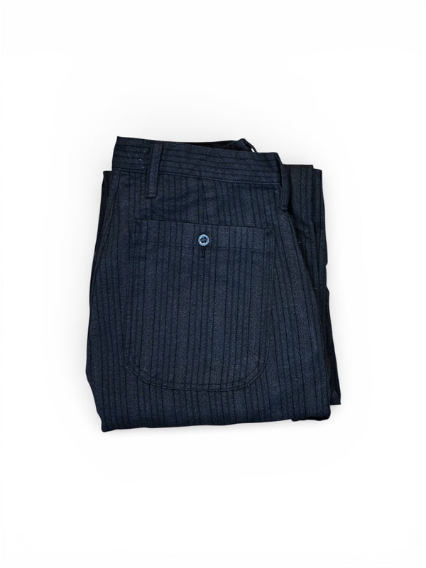 Folded dark blue pants on a white background