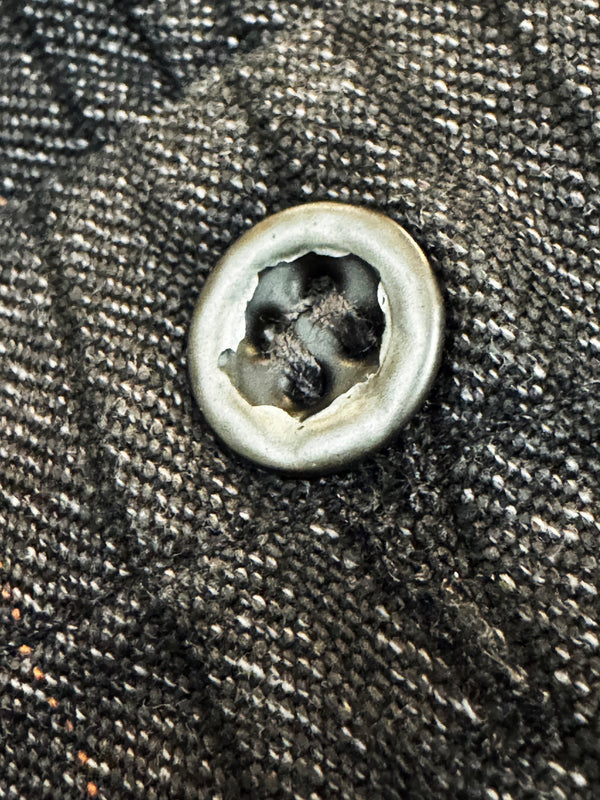 Close-up of a button on textured fabric