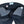 Dark blue denim jeans with striped lining on a white background